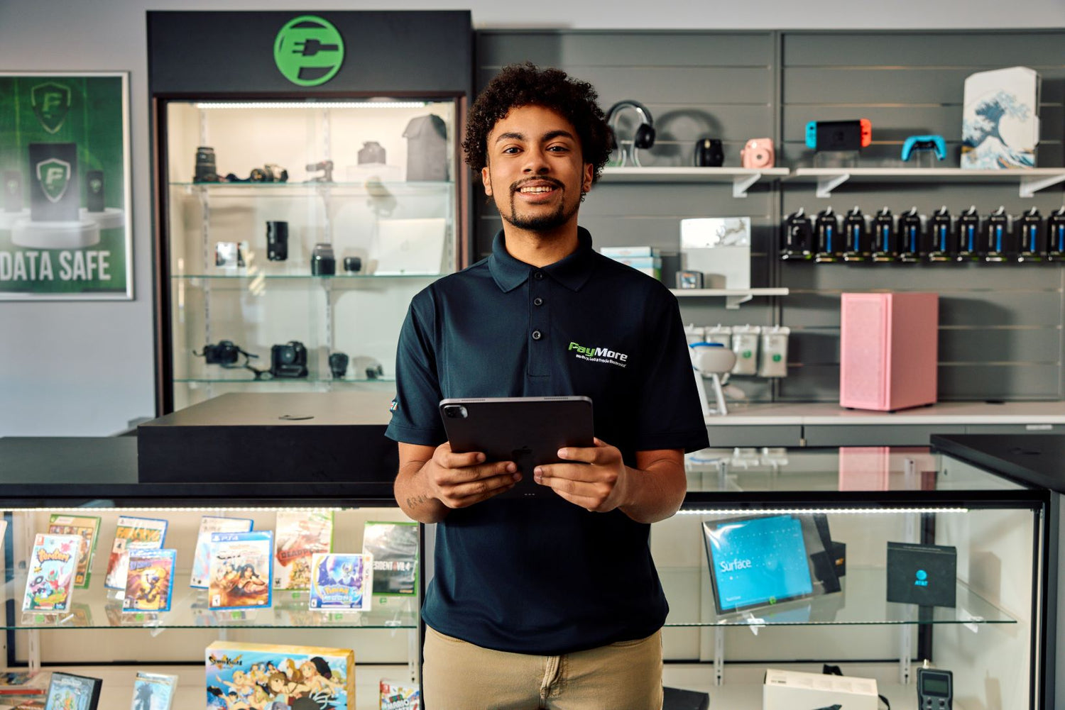 paymore employee holding a tablet and smiling
